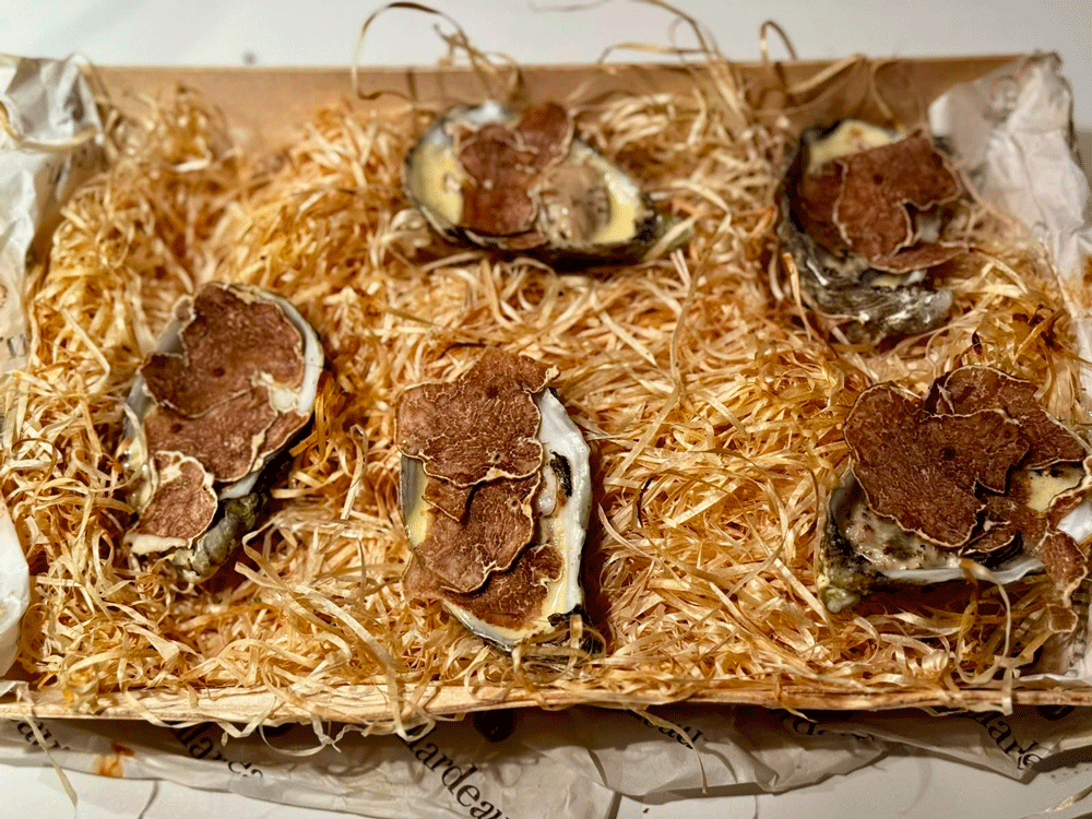 A tray of baked oysters with truffle homemade by a customer of il tartufo di massimo